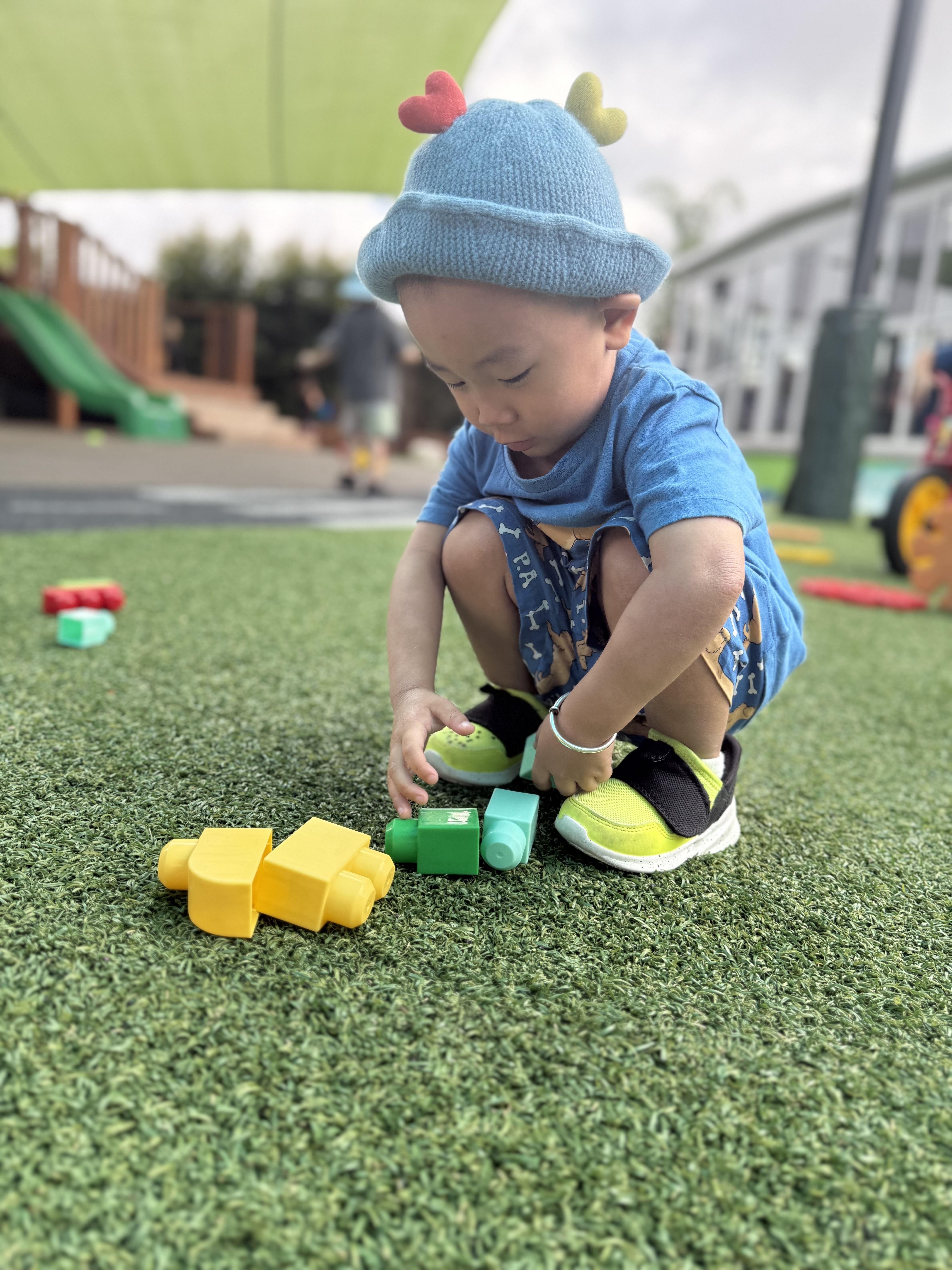 Children enjoying outdoor play in a well-equipped playground with safe equipment.